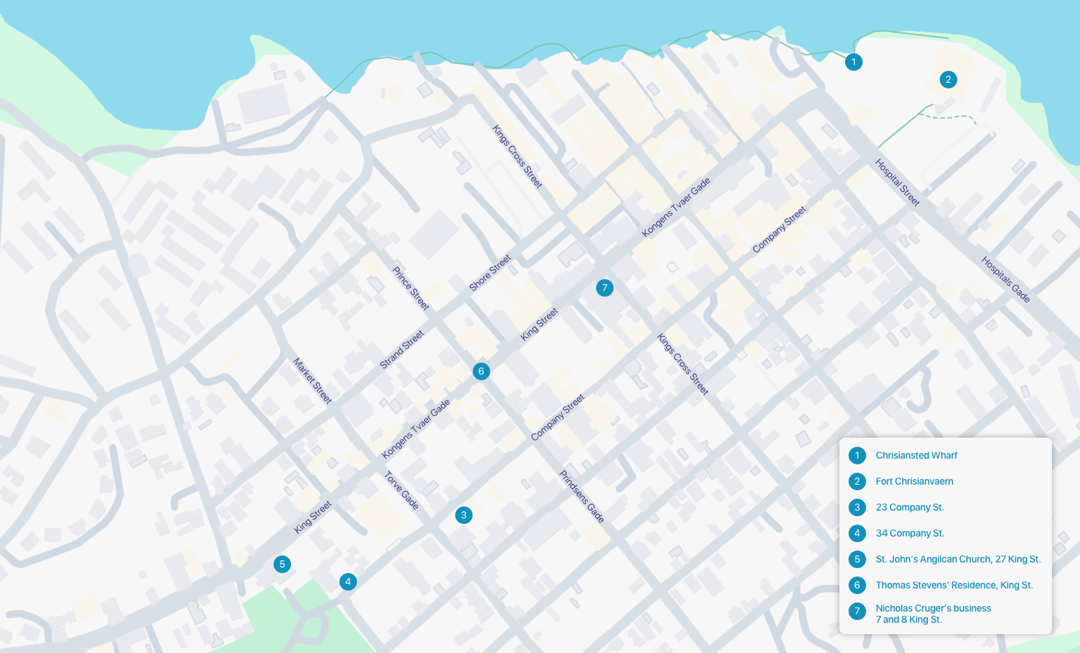A simplified street map of Christiansted, St. Croix, highlighting a walking tour with seven numbered stops. The route runs through the town’s grid of streets near the northern coastline, bordered by the sea at the top of the map. Each stop is marked with a blue numbered circle, and a legend in the bottom-right corner lists the corresponding sites:
	1.	Christiansted Wharf
	2.	Fort Christiansvaern
	3.	23 Company St.
	4.	34 Company St.
	5.	St. John’s Anglican Church, 27 King St.
	6.	Thomas Stevens’ Residence, King St.
	7.	Nicholas Cruger’s Business, 7 and 8 King St.

Major streets such as King Street, Company Street, and Strand Street are labeled, with stops concentrated between Hospital Street and Market Street. The map is designed to support a historical walking tour of sites related to Alexander Hamilton’s life in Christiansted.