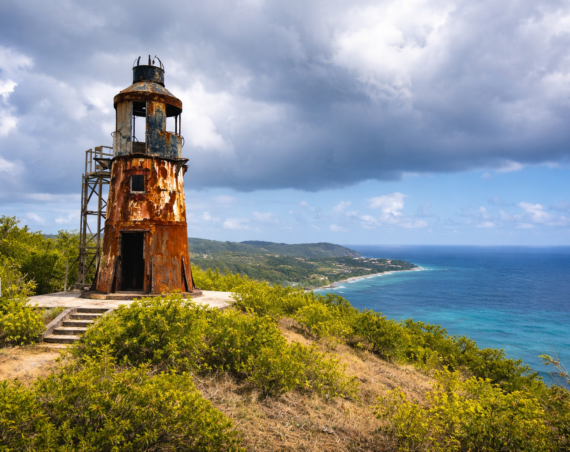 Ham's Bluff Lighthouse overlooking the north shore of St. Croix with turquoise ocean views and dramatic clouds.